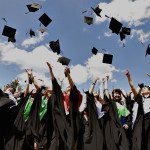 Medical University graduates throw up mortarboards during the ce